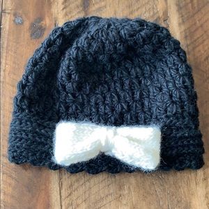 Black winter beanie with white accent bow